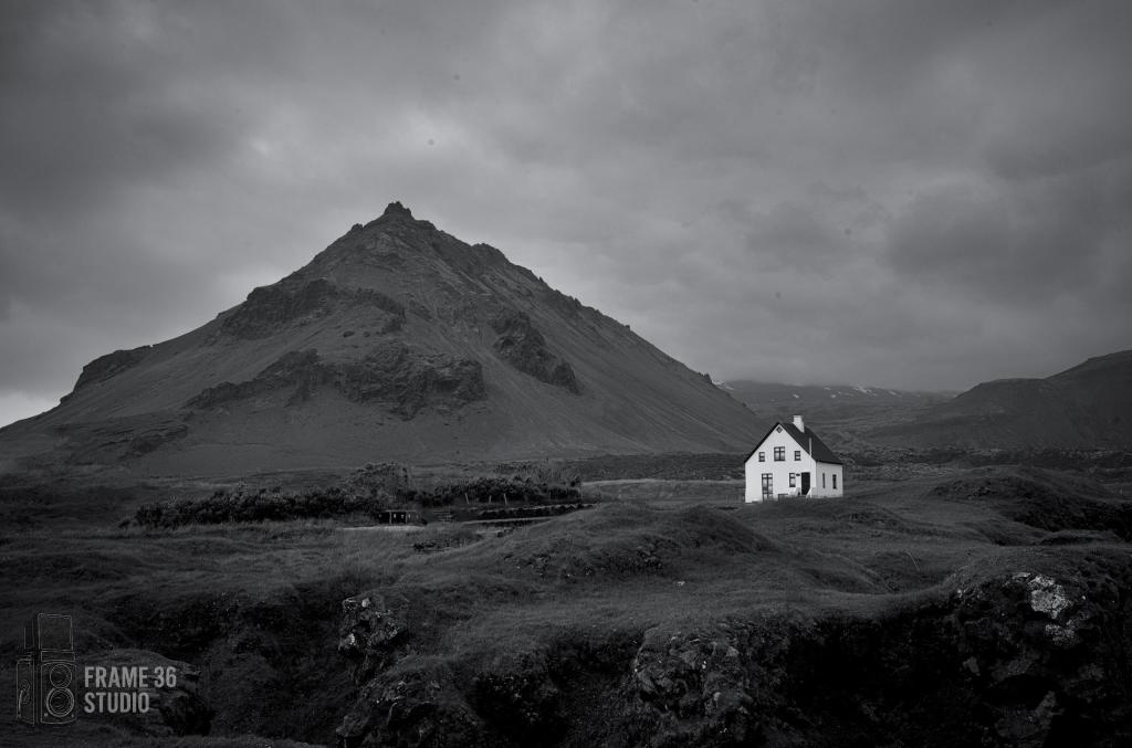 Lone white house against a dark Iceland Landscape