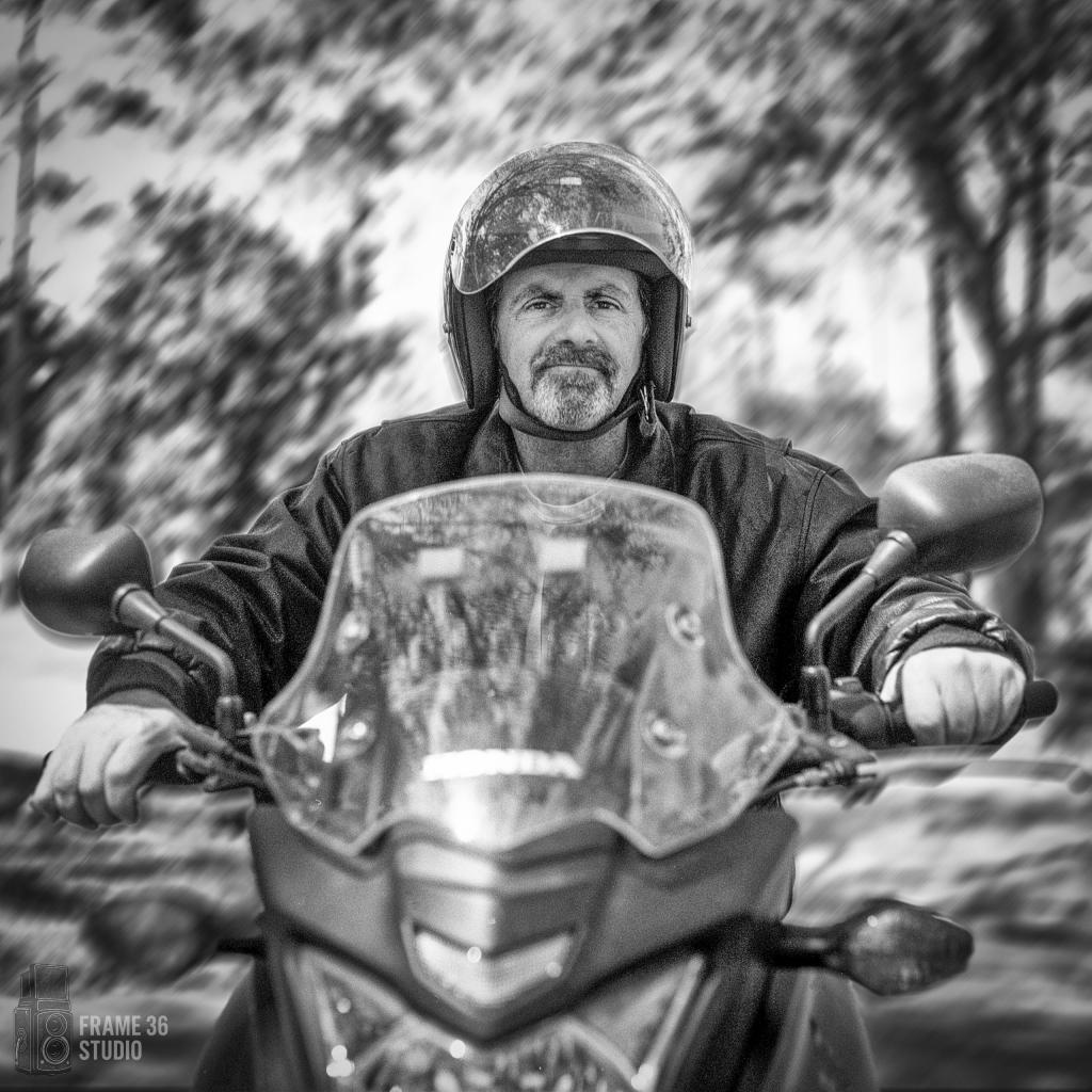 Promotional Materials Environmental portrait featuring a subject (on his motorcycle) that sells promotional materials.