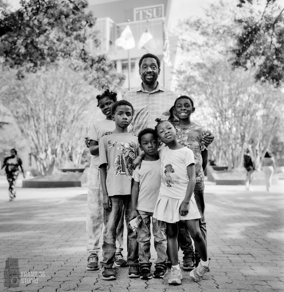 Non-Prifit Environmental portrait of a non-profit worker and his family in their organizational environment.