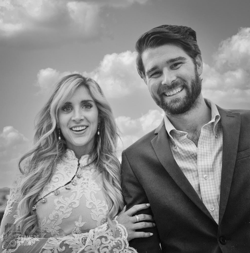 Black-and-white portrait of a smiling wedding couple